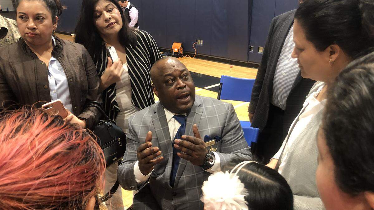Wake County Sheriff Gerald Baker talks with Hispanic residents who attended a community meeting on March 10, 2019, at St. Michael the Archangel Church in Cary.