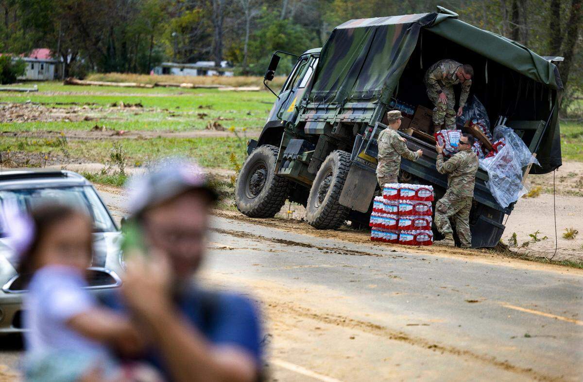 National Guard Troops from Southern Pines, N.C. deliver water to the hard hit village of Pensacola, N.C. in Yancey County on Thursday, October 3, 2024.