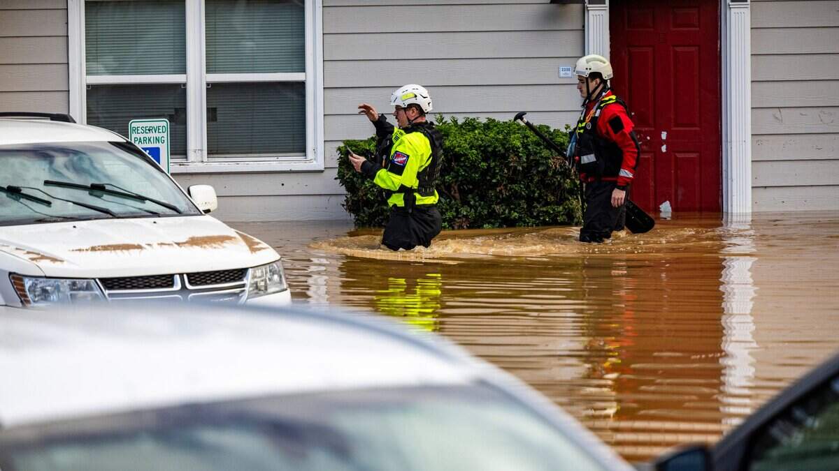 A water rescue unit with the Durham Fire Department knocks on doors at Rippling Streams Townhomes in the Old Farm neighborhood along the Eno River in Durham on Monday morning, July 7, 2025, after flash flooding caused by Tropical Storm Chantal.