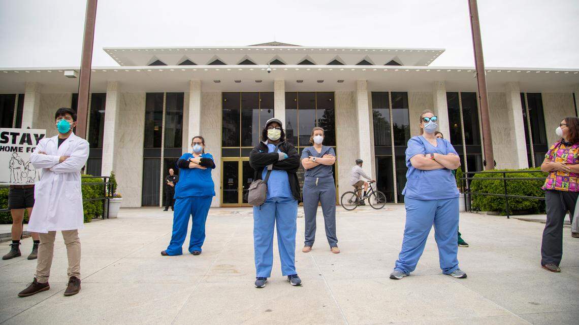 Counter protesters stand in front of the Legislative Building near a ReOpen NC rally Tuesday, May 5, 2020 in downtown Raleigh.