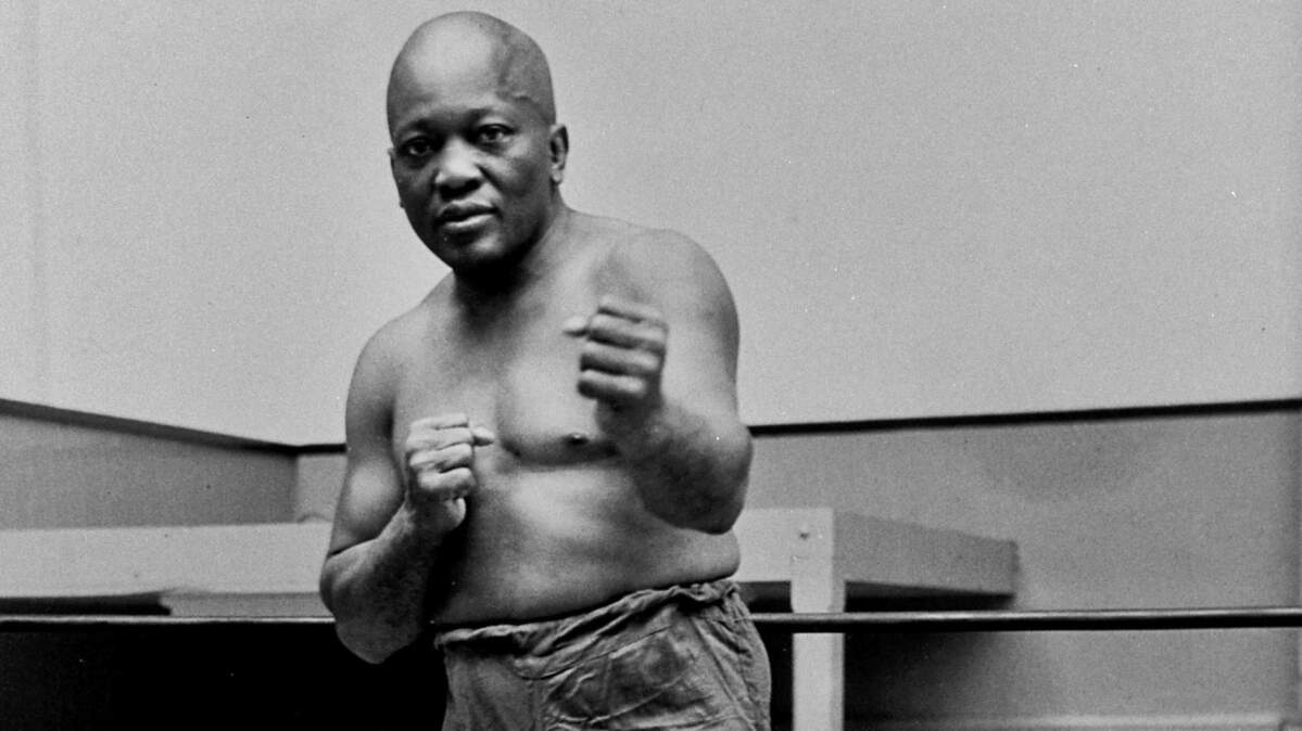 In this 1932 file photo, boxer Jack Johnson, the first black world heavyweight champion, poses in New York City. President Donald Trump on Thursday, May 24, 2018, granted a rare posthumous pardon to boxing's first black heavyweight champion, clearing Jack Johnson’s name more than 100 years after a racially charged conviction.