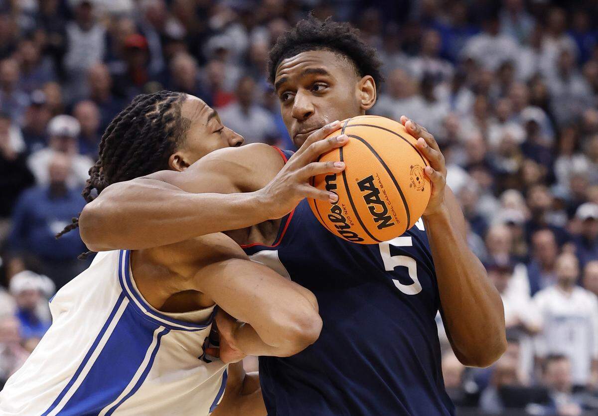 UConn's Tarris Reed Jr. (5) works against Duke’s Maliq Brown (6) during the first half of Duke’s game against Connecticut in the NCAA Men’s Tournament East Regional Final at Capital One Arena in Washington, D.C., Sunday, March 29, 2026.