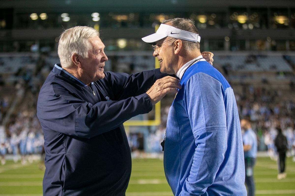 North Carolina coach Mack Brown talks with Pitt coach Pat Narduzzi prior to their game on Saturday, October 29, 2022 at Kenan Stadium in Chapel Hill, N.C.