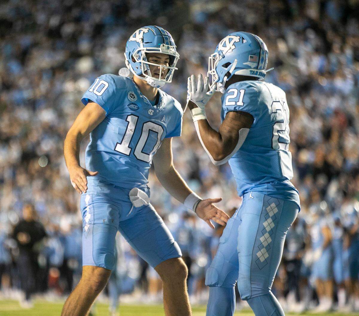 North Carolina quarterback Drake Maye congratulates Elijah Green (21) after Green’s game winning touchdown on a two yard run to give the Tar Heels’ 28-24 lead in the fourth quarter against Pitt on Saturday, October 29, 2022 at Kenan Stadium in Chapel Hill, N.C.