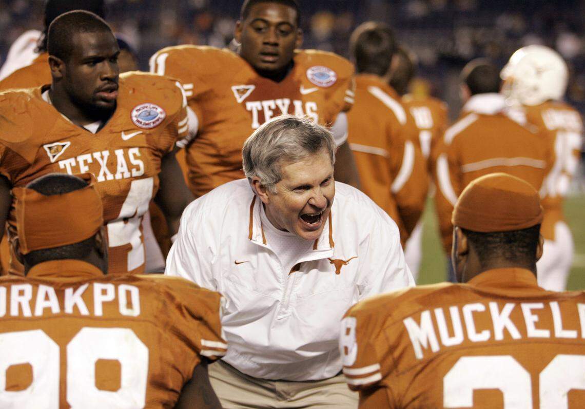 Texas head coach Mack Brown, center, urges his players on during the fourth quarter of the Holiday Bowl football game against Arizona State on Thursday, Dec. 27, 2007 in San Diego. Texas won 52-34.