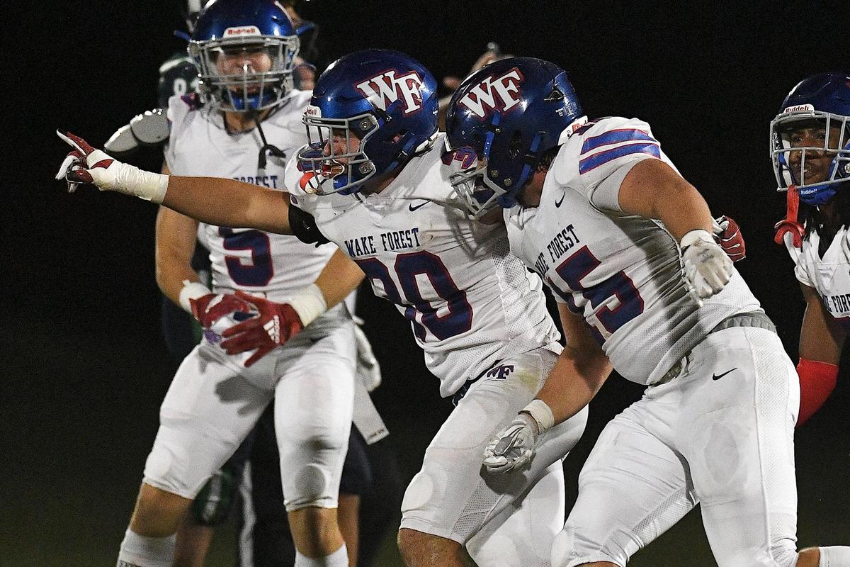 Wake Forest’s Zane Williams (30) celebrates Brady Cole’s (15) interception during the second half against Leesville Road. The Wake Forest Cougars and the Leesville Road Pride met in a football game in Raleigh, N.C. on September 15, 2023.