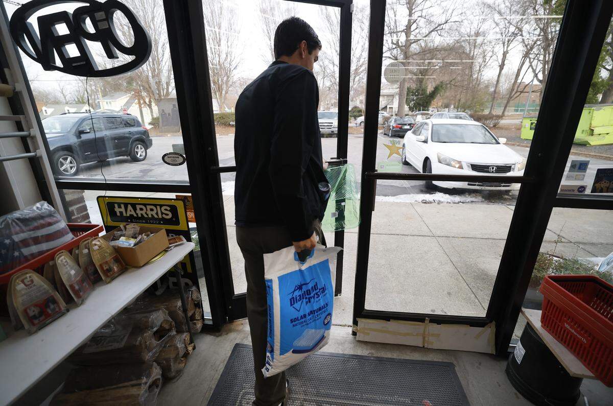 Sam Thompson buys a 40 lbs bag of salt at Handyman Hardware in Raleigh, N.C., Friday morning, Jan. 30, 2026. The hardware store sold out of the salt at 9:18 a.m.