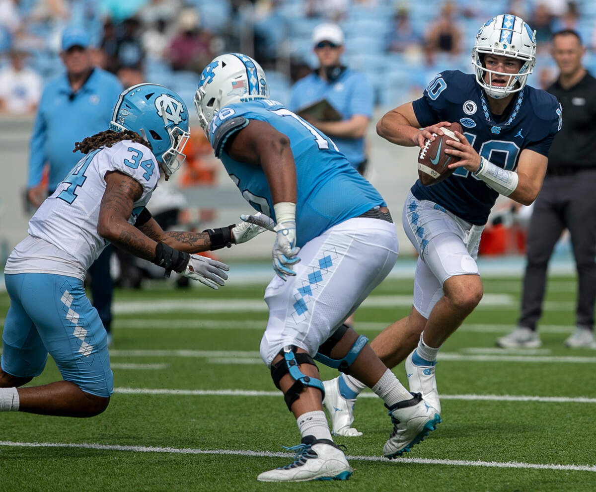 North Carolina quarterback Drake Maye (10) rolls out of the pocket as he looks for an open receiver during the Tar Heels’ spring football game on Saturday, April 15, 2023 at Kenan Stadium in Chapel Hill, N.C.