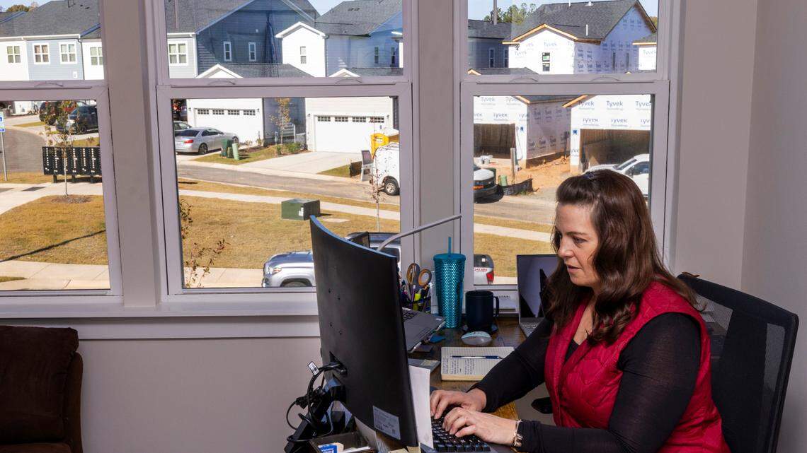 Amanda Suchanek, 38, works at her home office in her new townhouse in the Townes at Chatham Park subdivision in Pittsboro. She is one of hundreds of millennials who have flooded the Triangle’s housing market.
