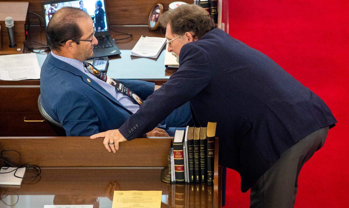 House Republicans Michael Speciale, left, and Larry G. Pittman confer as the North Carolina House debates before passing its $1.7 billion COVID-19 response bill, called the Pandemic Response Act, on Thursday, April 30, 2020 at the General Assembly.
