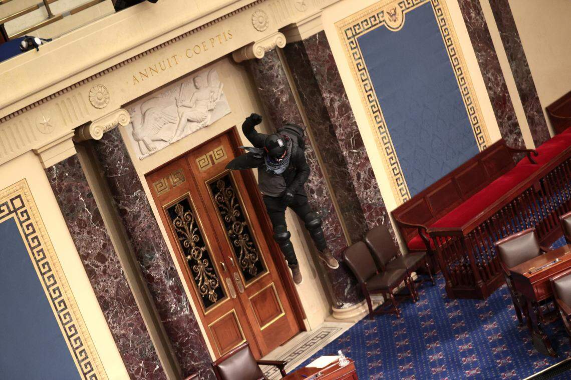 A rioter enters the Senate Chamber on Wednesday, Jan. 6, 2021 in Washington, D.C. Congress held a joint session today to ratify President-elect Joe Biden’s 306-232 Electoral College win over President Donald Trump. A group of Republican senators said they would reject the Electoral College votes of several states unless Congress appointed a commission to audit the election results.