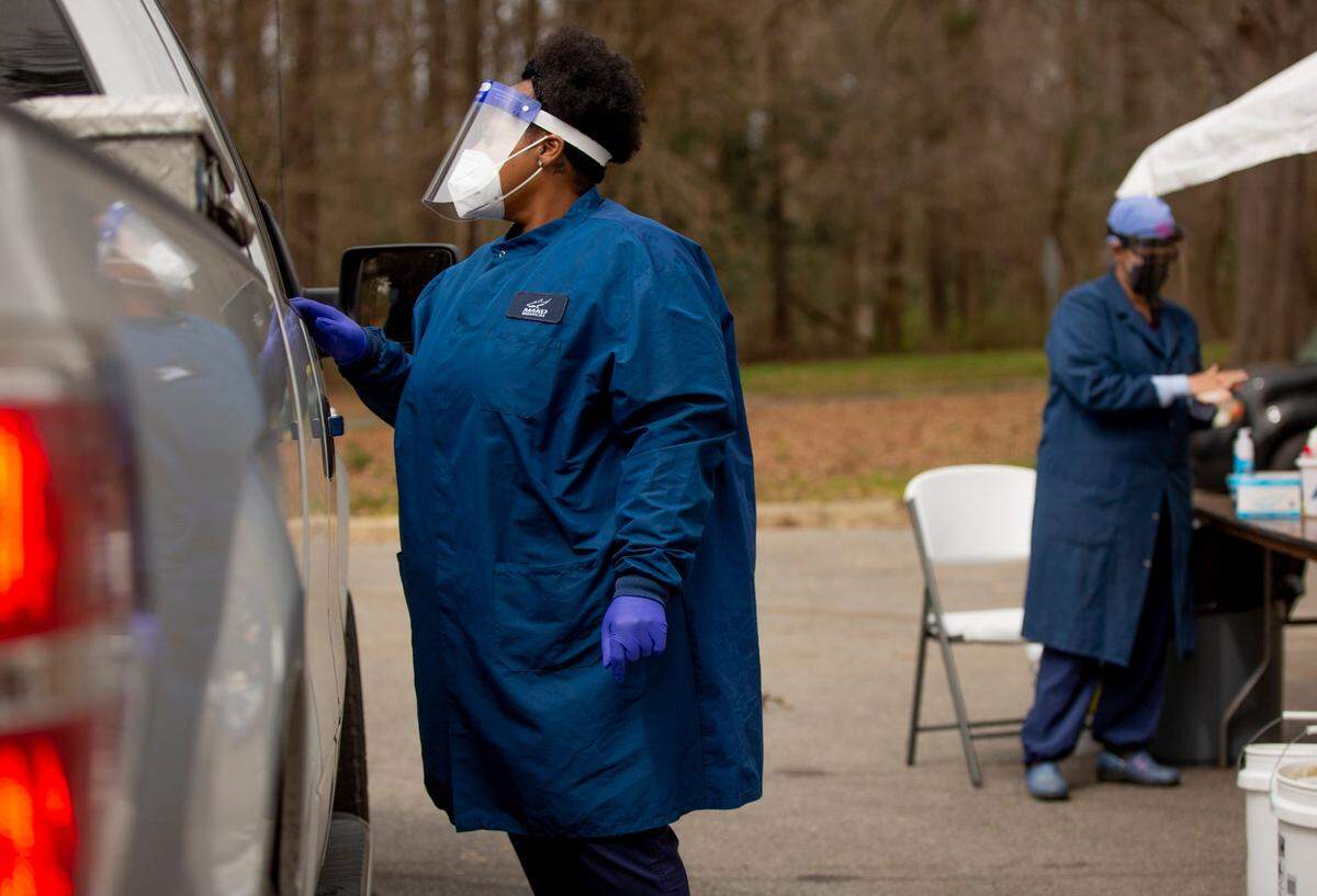 Lucretia Davis, left, and Amanda Trango administer free COVID-19 tests at Biltmore Hills Park, on Monday, Mar. 15, 2021, in Raleigh, N.C.