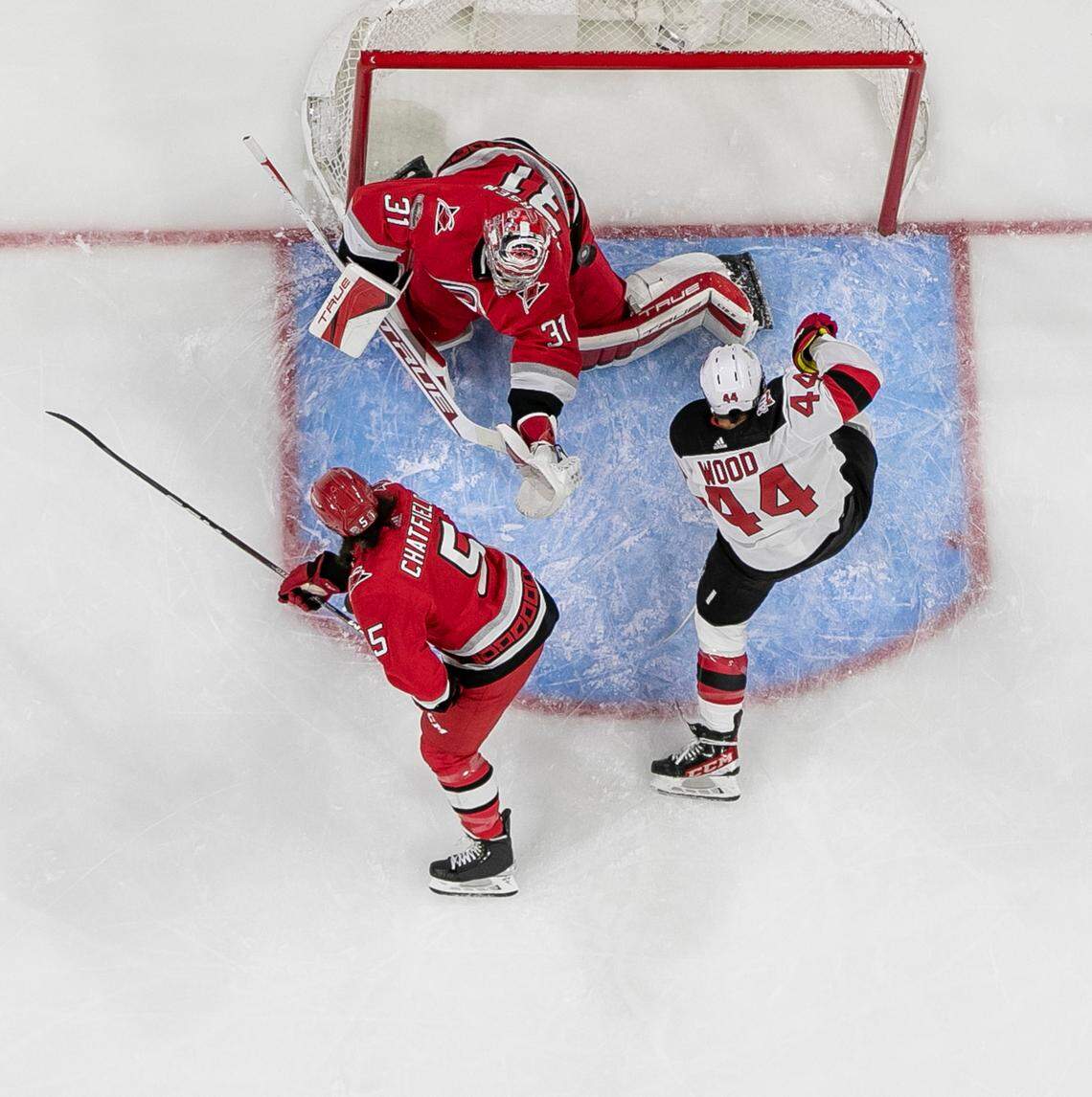 Carolina Hurricanes goalie Frederik Andersen (31) deflects a scoring attempt by New Jersey Devils Miles Wood (44) in the first period during Game 2 of their second round Stanley Cup playoff series on Friday, May 5, 2023 at PNC Arena in Raleigh, N.C. Andersen made 28 saves in the Hurricanes’ 6-1 victory.