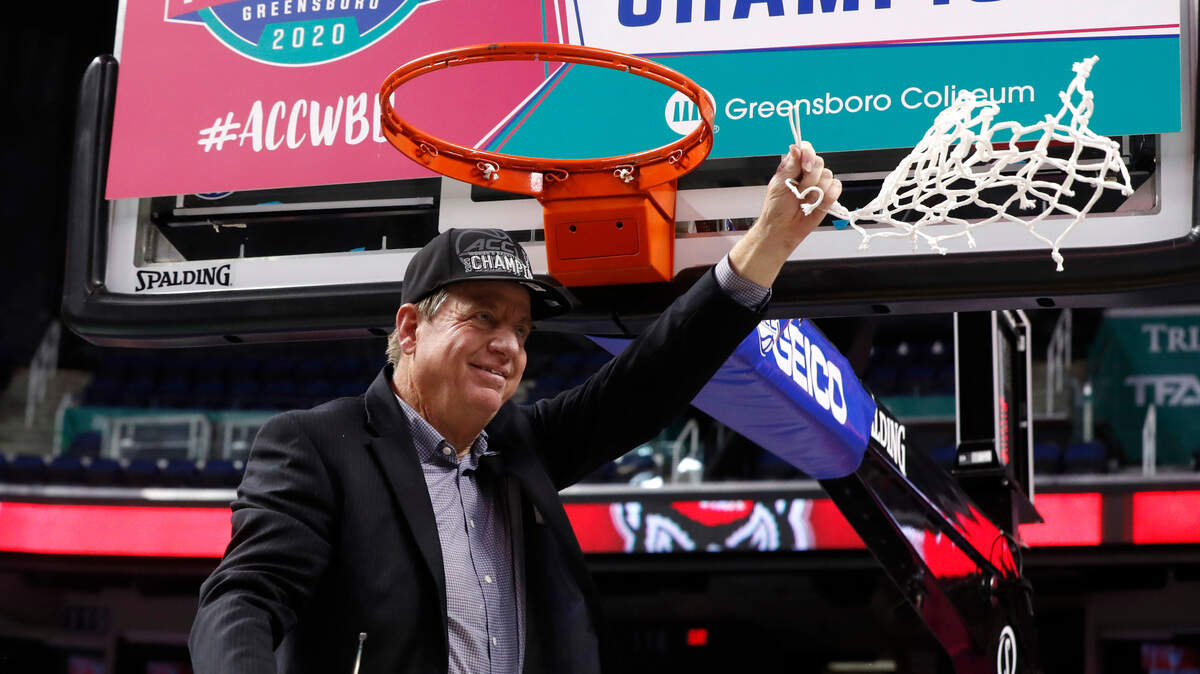 N.C. State head coach Wes Moore celebrates after cutting down the net after the Wolfpack’s 71-66 victory over the Florida State Seminoles in the ACC Tournament finals at Greensboro Coliseum in Greensboro, N.C., Sunday, March 8, 2020.