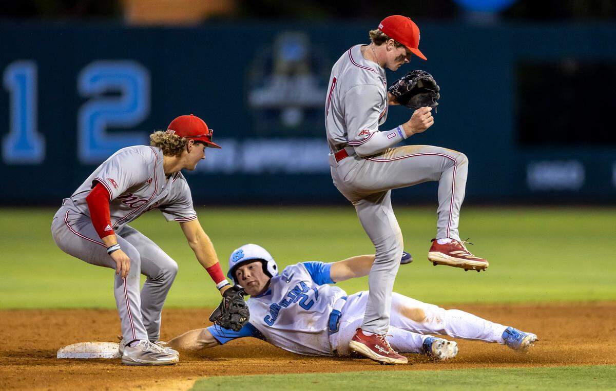 North Carolina outfielder Kane Kepley (27) steals second base under N.C. State short stop Justin DeCriscio (8) and second baseman Luke Nixon (0) in the bottom of the seventh inning on Friday, May 9, 2025 at Boshamer Stadium in Chapel Hill, N.C.