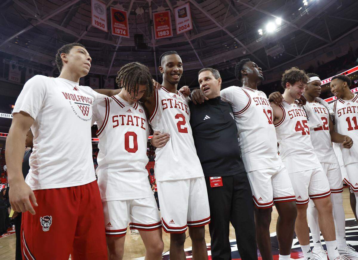 N.C. State head coach Will Wade, center, stands with his team at half court during the playing of the alma mater following the Wolfpack’s 114-66 win over North Carolina Central at Lenovo Center on Monday, Nov. 3, 2025, in Raleigh, N.C.