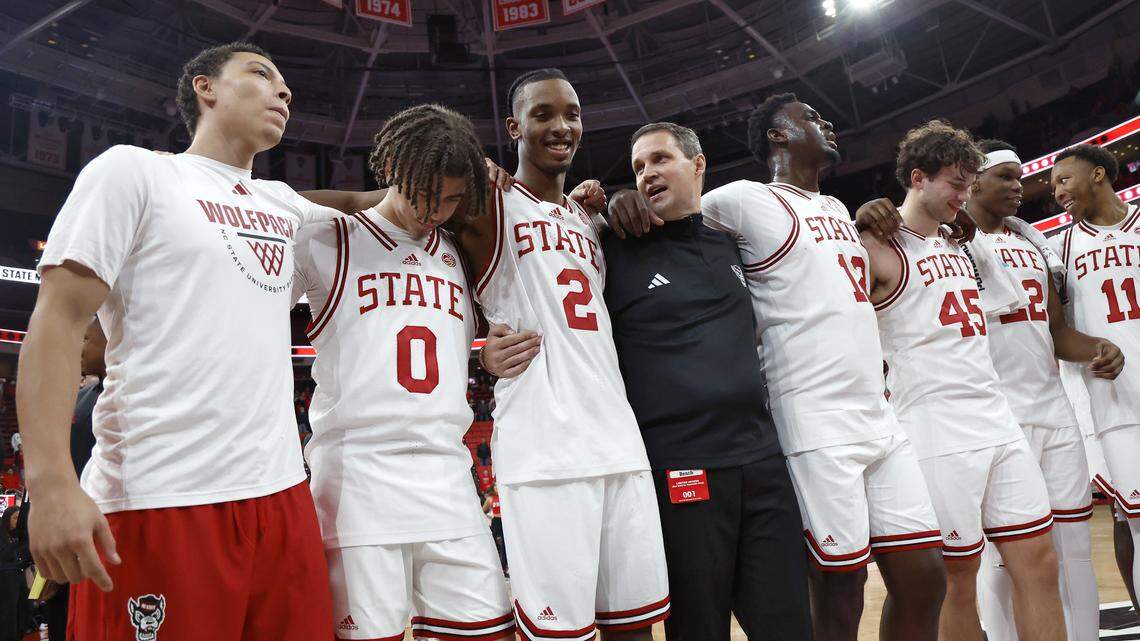 N.C. State head coach Will Wade, center, stands with his team at half court during the playing of the alma mater following the Wolfpack’s 114-66 win over North Carolina Central at Lenovo Center on Monday, Nov. 3, 2025, in Raleigh, N.C.