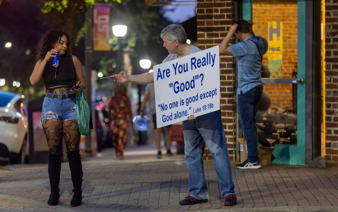 Jeff Duffy from Shiloh Presbyterian Church hands out literature on Glenwood Avenue on Friday July 21, 2023 in Raleigh, N.C. Duffy encourages those passing by to follow Christ and consider attending services at Shiloh.
