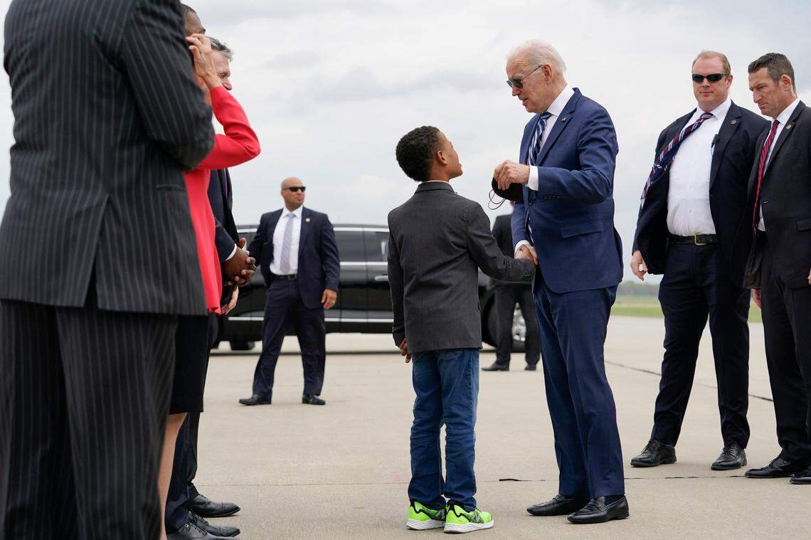 President Joe Biden shakes hands with Environmental Protection Agency Administrator Michael Regan’s son Matthew, 7, as he arrives at Piedmont Triad International Airport, in Greensboro, N.C., Thursday, April 14, 2022, en route to North Carolina Agricultural and Technical State University.