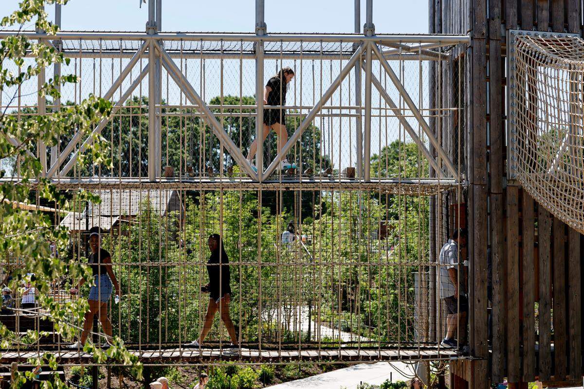 Participants enjoy the bridges at Gipson Play Plaza at Dix Park during a preview day Saturday, May 24, 2025. The park will officially open with a grand opening celebration on June 6th, 7th and 8th.