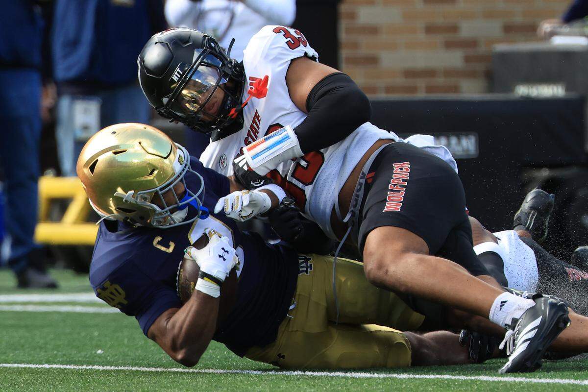 Notre Dame quarterback Will Pauling is tackled by N.C. State’s Kenny Soares of the NC State Wolfpack in the first quarter October 11, 2025 in South Bend, Indiana. 