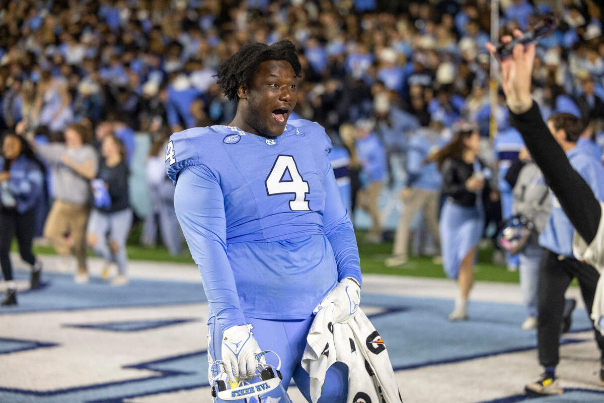 North Carolina’s Travis Shaw (4) reacts as he watches fans storm the field to celebrate the Tar Heels’ 47-45 victory in double overtime on Saturday, Nov. 11, 2023 at Kenan Stadium in Chapel Hill, N.C.