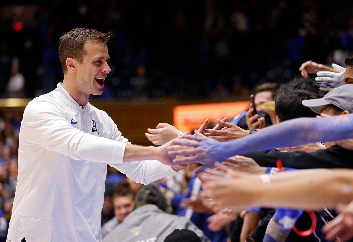 Duke head coach Jon Scheyer is congratulated by fans following the Blue Devils’ 81-65 win over Virginia Tech on Saturday, Feb. 25, 2023, at Cameron Indoor Stadium in Durham, N.C.