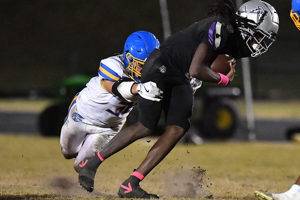 Garner linebacker Joseph Cappelletti (36) sacks South Garner quarterback Chase Hardy (8) during the first half. The South Garner Titans and the Garner Trojans met in a conference football game in Raleigh, N.C. October 17, 2025