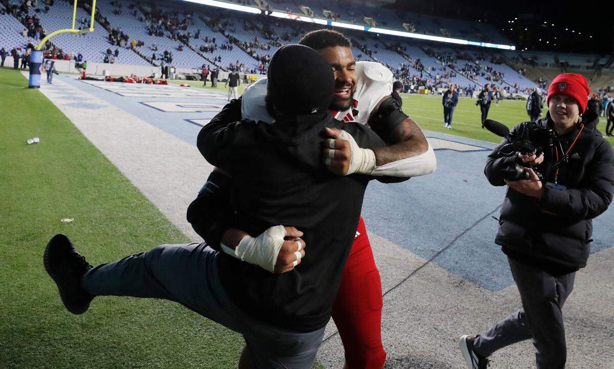 N.C. State defensive end Davin Vann (1) celebrates after N.C. State’s 35-30 victory over UNC at Kenan Stadium in Chapel Hill, N.C., Saturday, Nov. 30, 2024.