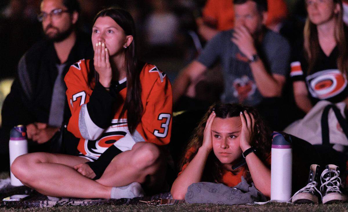 Carolina Hurricanes fans react while watching the second period during a watch party for Game 2 of the Stanley Cup Final against the Vegas Golden Knights in Moore Square on Thursday, June 4, 2026, in Raleigh, N.C.