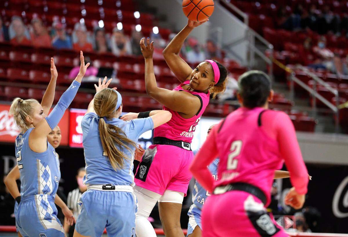 N.C. State’s Kayla Jones (25) passes to Raina Perez (2) during the second half of N.C. State’s 82-63 victory over UNC in the annual Play4Kay game at Reynolds Coliseum in Raleigh, N.C., Sunday, February 21, 2021.