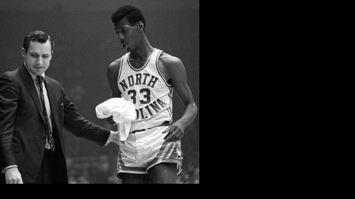 Smith with Charlie Scott in the 1969 ACC Tournament.  Smith signed Scott as the first black scholarship athlete at UNC in 1966.