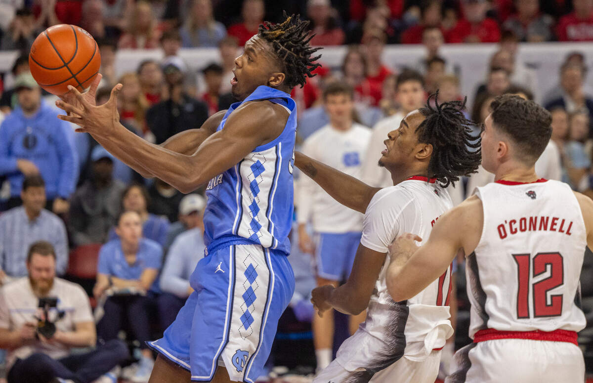 North Carolina’s Harrison Ingram (55) goes after an offensive rebound ahead of N.C. State’s Dennis Parker Jr. (11) in the second half on Wednesday, January 10, 2024 at PNC Arena in Raleigh, N.C. Ingram collected a record 19 rebounds in the Tar Heels’ victory.