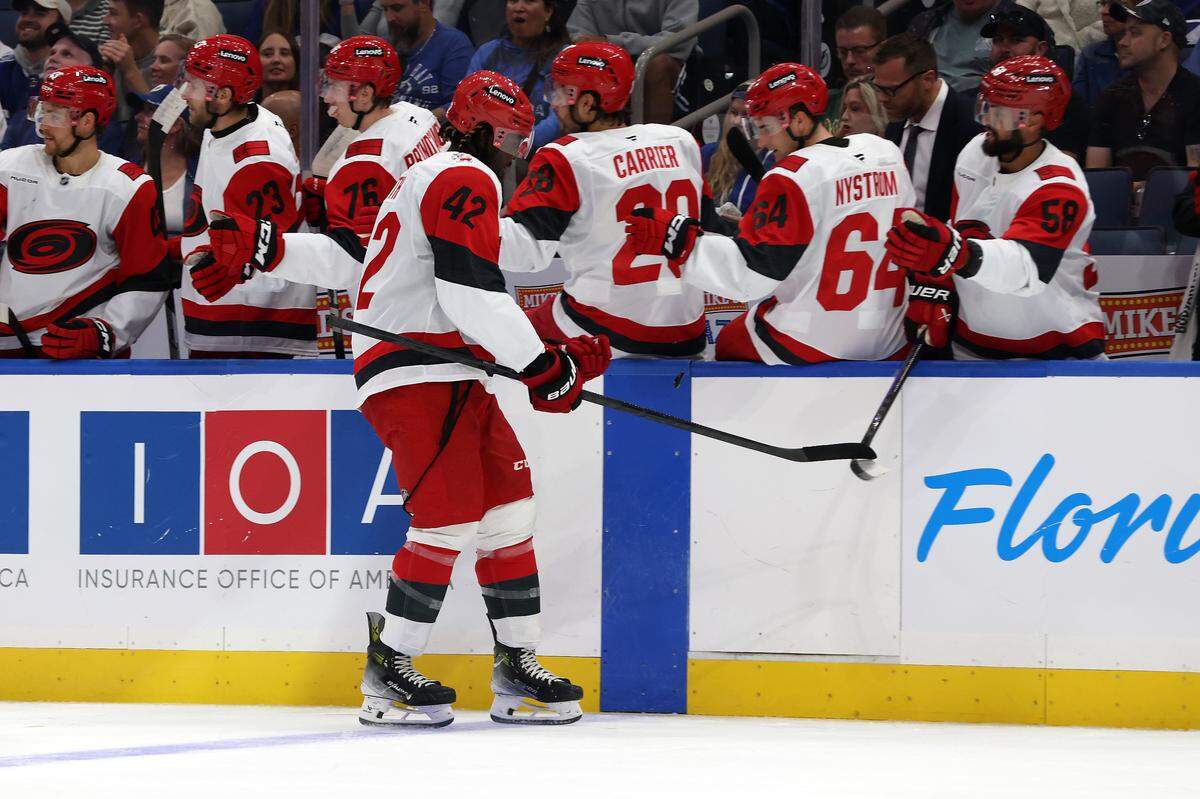 Carolina Hurricanes right wing Givani Smith (42) is congratulated after he scored a goal against the Tampa Bay Lightning during the first period at Benchmark International Arena. 