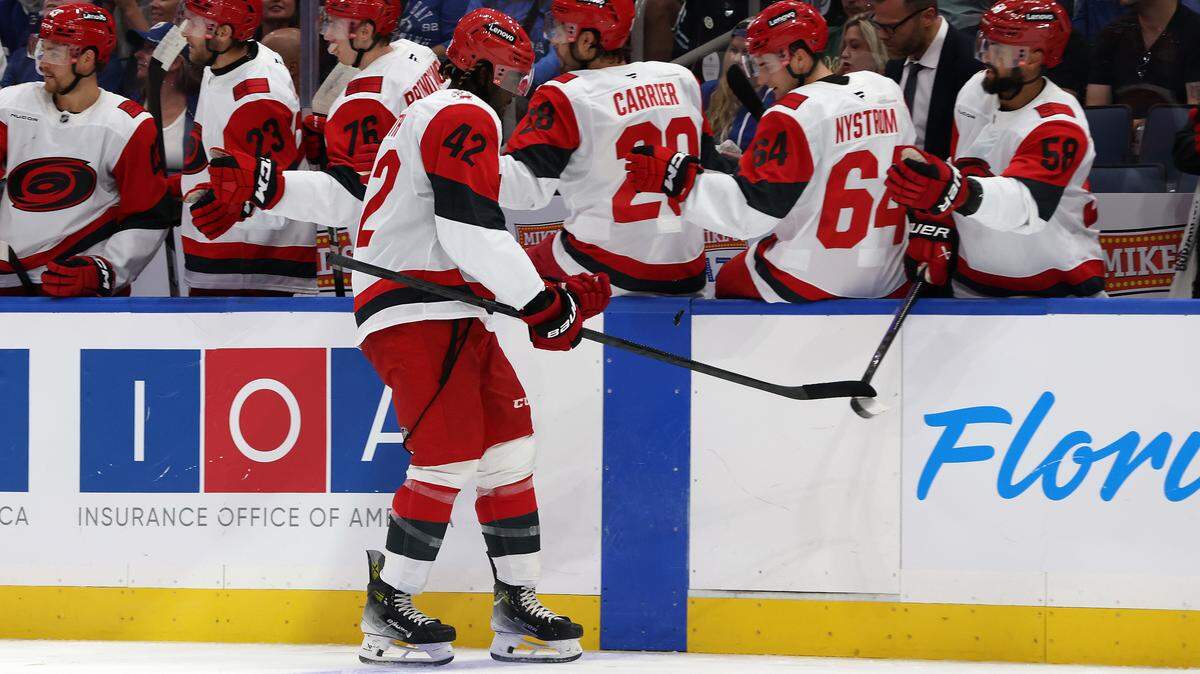 Sep 26, 2025; Tampa, Florida, USA; Carolina Hurricanes right wing Givani Smith (42) is congratulated after he scored a goal against the Tampa Bay Lightning during the first period at Benchmark International Arena. Mandatory Credit: Kim Klement Neitzel-Imagn Images