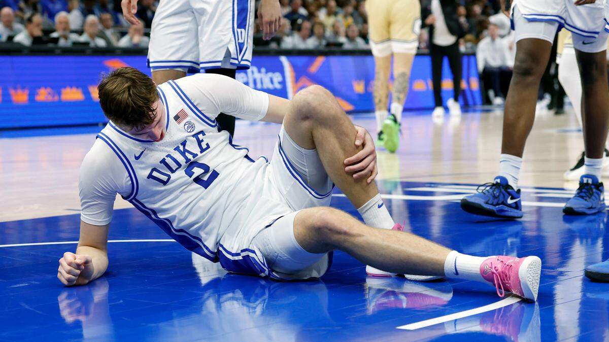 Duke’s Cooper Flagg (2) holds his left leg after being injured during the first half of Duke’s game against Georgia Tech in the quarterfinals of the 2025 ACC Men’s Basketball Tournament at the Spectrum Center in Charlotte, N.C., Thursday, March 13, 2025.