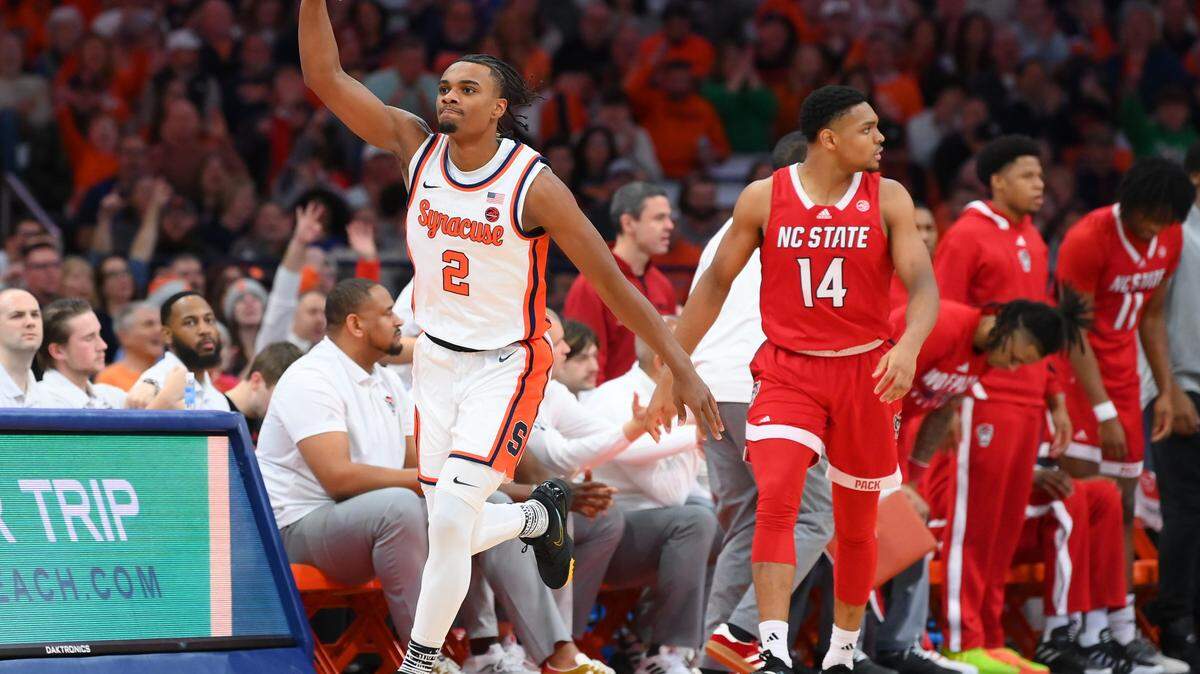 Jan 27, 2024; Syracuse, New York, USA; Syracuse Orange guard JJ Starling (2) reacts to his three-point basket as North Carolina State Wolfpack guard Casey Morsell (14) looks on during the first half at the JMA Wireless Dome. Mandatory Credit: Rich Barnes-USA TODAY Sports