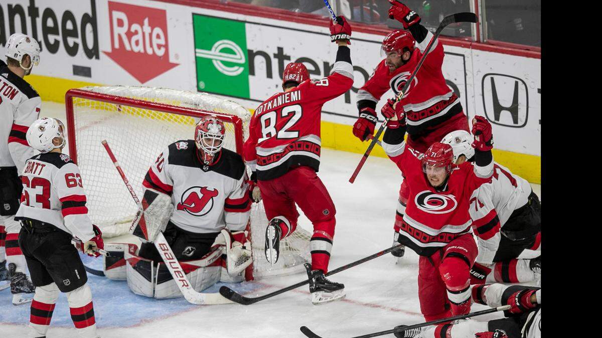 The Carolina Hurricanes Jesperi Kotkaniemi (82) scores the second of his two goals on New Jersey Devils goalie Akira Schmid (40) in the second period during Game 2 of their second round Stanley Cup playoff series on Friday, May 5, 2023 at PNC Arena in Raleigh, N.C.