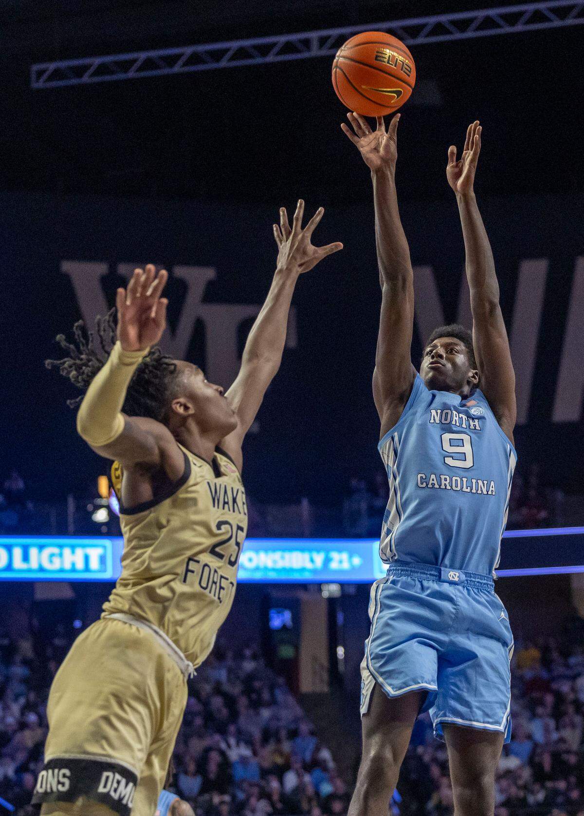 North Carolina forward Drake Powell (9) scores on Wake Forest’s Tre’Von Spillers (25) in the second half on Tuesday, January 21, 2025 at Lawrence Joel Coliseum in Winston-Salem, N.C.