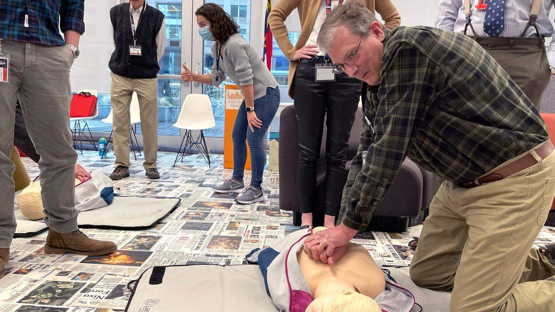 News & Observer employees, including Scott Sharpe, right, participate in CPR training in the newsroom in Raleigh on Tuesday, Jan. 17, 2023.