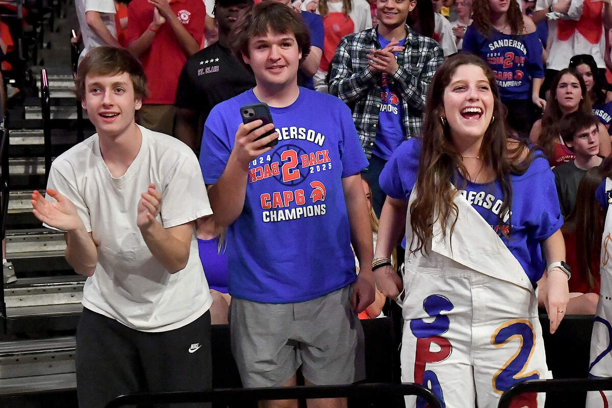 Sanderson fans James Hasty, left, James Cozart, and Sarah Puckett cheer on their team before the start of the gsme against New Hanover. The Sanderson Spartans and the New Hanover Wildcats met in the NCHSAA 4A East Regional Final in Winston-Salem, N.C. on March 12, 2025.