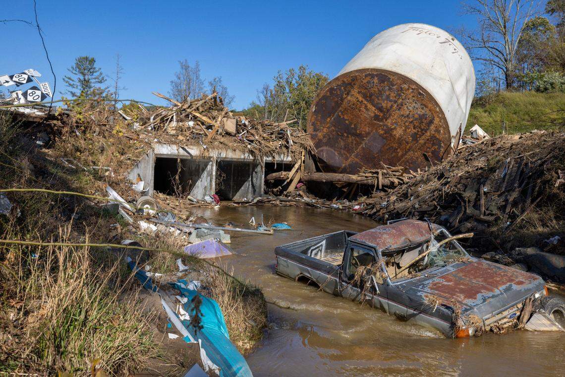 Little Crabtree Creek is littered with storm debris and vehicles on Thursday, October 17, 2024, three weeks after Hurricane Helene flooded the South Toe River and adjacent creeks near Micaville in Yancey County, N.C.