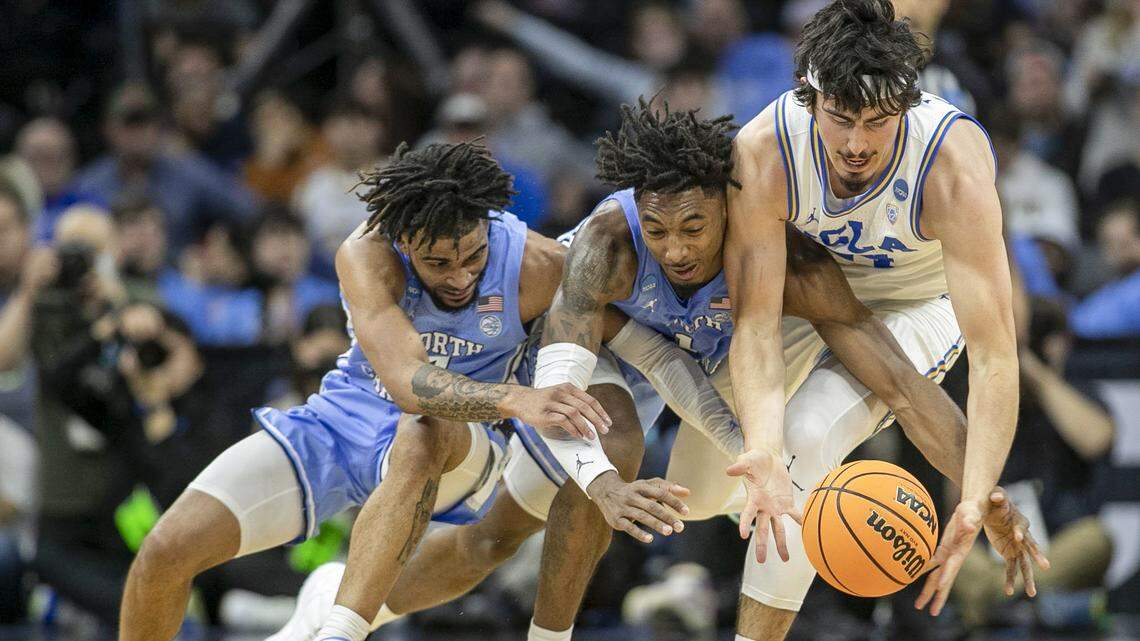 North Carolina’s R.J. Davis (4) and Leaky Black (1) battle with UCLA’s Jaime Jaquez Jr. (24) during the first half on Friday, March 25, 2022 during the NCAA East Regional semi-final at Wells Fargo Center in Philadelphia, Pa.