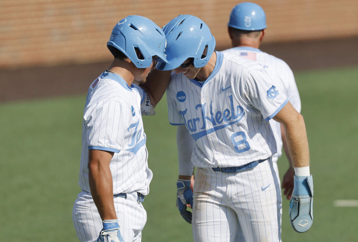 North Carolina's Macon Winslow (6) and Owen Hull (8) bump helmets in the eighth inning during UNC’s 4-3 victory over USC at Boshamer Stadium to win the Chapel Hill Super Regional Sunday, June 7, 2026.