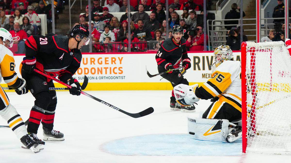 Nov 18, 2023; Raleigh, North Carolina, USA; Pittsburgh Penguins goaltender Tristan Jarry (35) stops Carolina Hurricanes center Sebastian Aho (20) scoring attempt during the first period at PNC Arena. Mandatory Credit: James Guillory-USA TODAY Sports