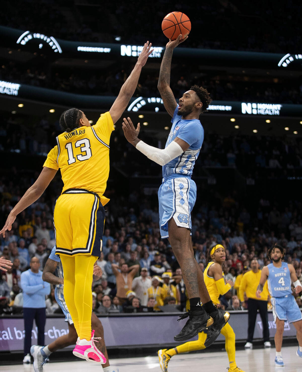 North Carolina’s Leaky Black (1) shoots over Michigan’s Jett Howard (13) in the second half against Michigan on Wednesday, December 21, 2022 at the Spectrum Center in Charlotte, N.C.