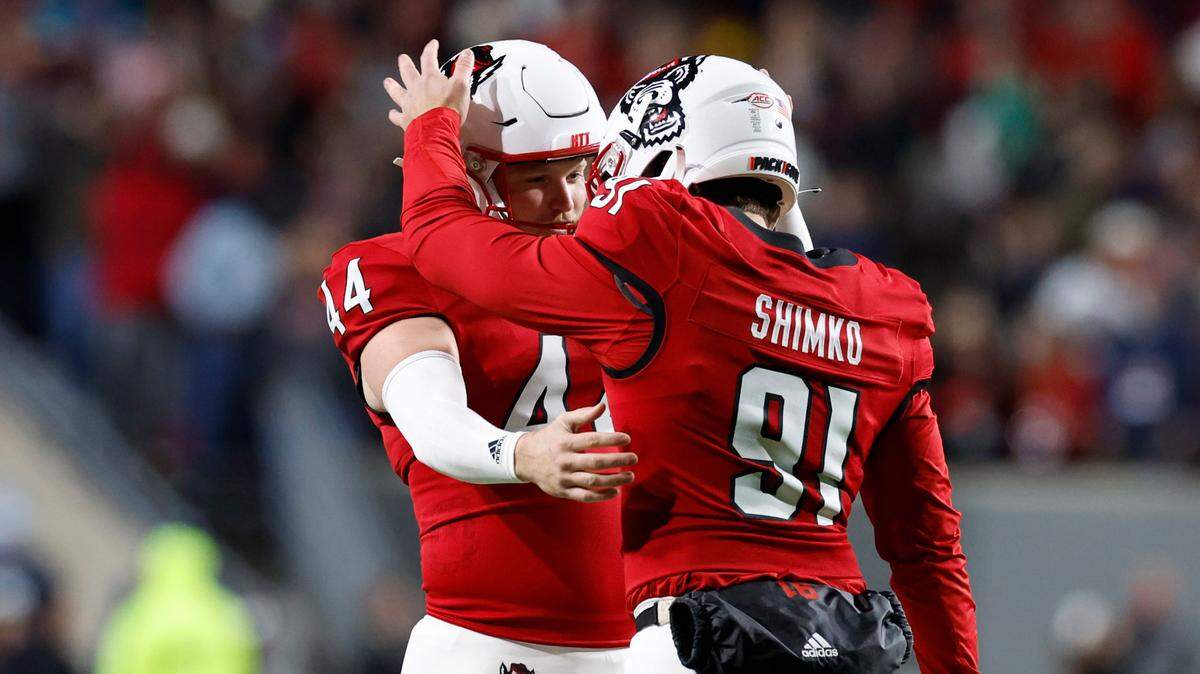 N.C. State long snapper Joe Shimko (91) congratulates kicker Brayden Narveson (44) after Narveson kicked a 32-yard field during the first half of N.C. State’s game against UNC at Carter-Finley Stadium in Raleigh, N.C., Saturday, Nov. 25, 2023.