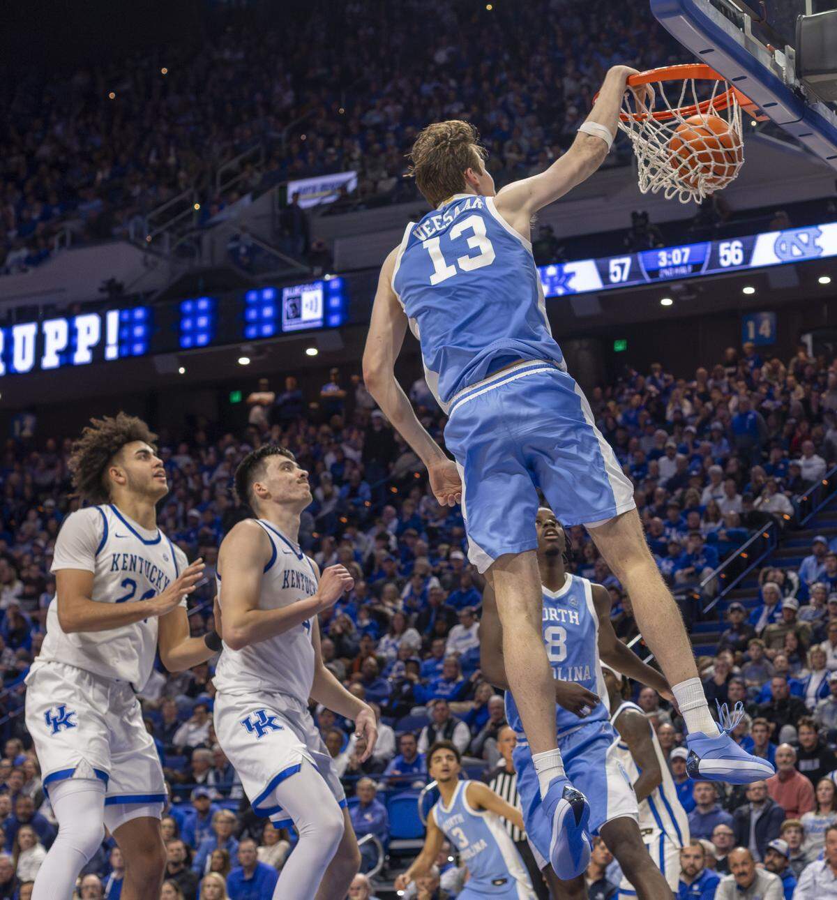 North Carolina center Henri Veesaar (13) breaks to the basket for a dunk ahead of Kentucky forward Andrija Jelavic (4) in the second half on Tuesday, December 2, 2025 at Rupp Arena in Lexington, Ky. Veesaar lead the Tar Heels with 17 points.