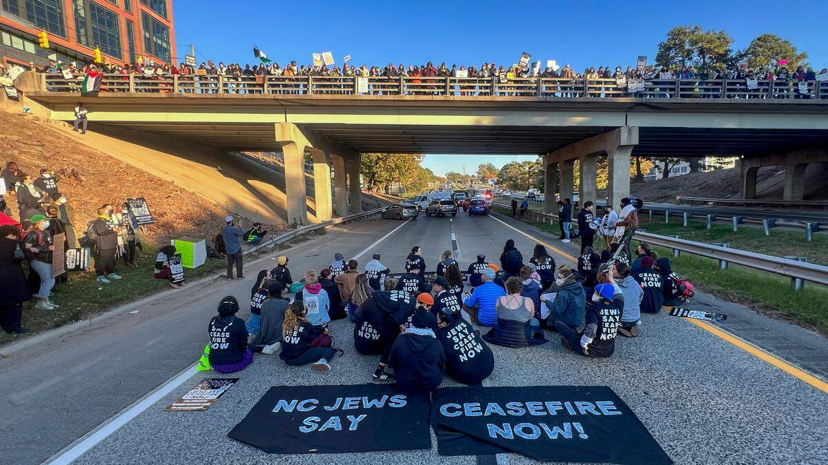Protesters block the northbound lanes of the Durham Freeway at the South Magnum Street bridge for hours Thursday evening, Nov. 2, 2023 while demanding a ceasefire in the Israel-Gaza War as police warned of arrests.