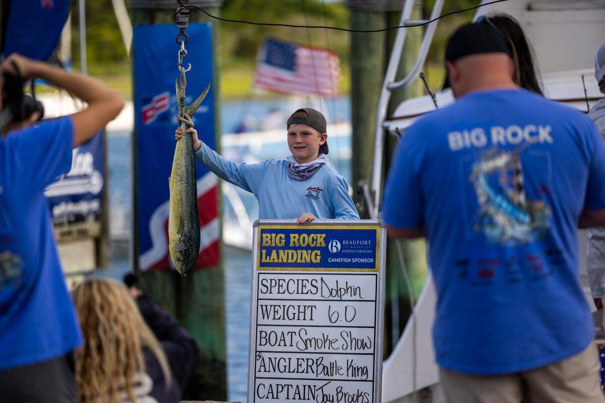 Battle King poses with a 6-pound dolphin fish during a weigh-in on Wednesday, June 12, 2024 at Big Rock Landing in Morehead City during the 66th Annual Big Rock Blue Marlin Tournament.